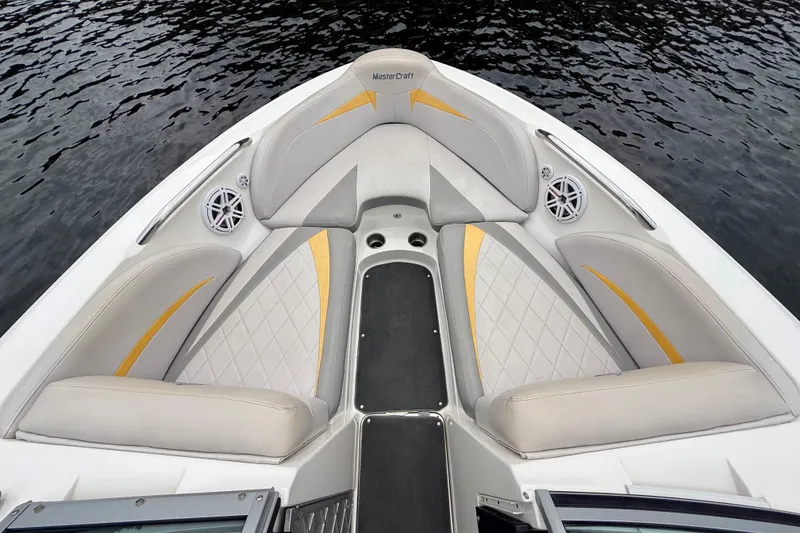 Slide: The Image of 2009 MasterCraft X30 boat interior with cushioned seating and water backdrop. - 20