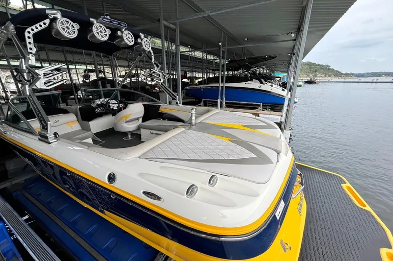 Slide: The Image of 2009 MasterCraft X30 boat docked, featuring sleek design and vibrant yellow accents. - 22