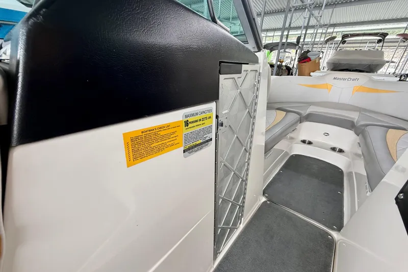 Slide: The Image of 2009 MasterCraft X30 interior with seating, capacity label, and sleek design. - 27