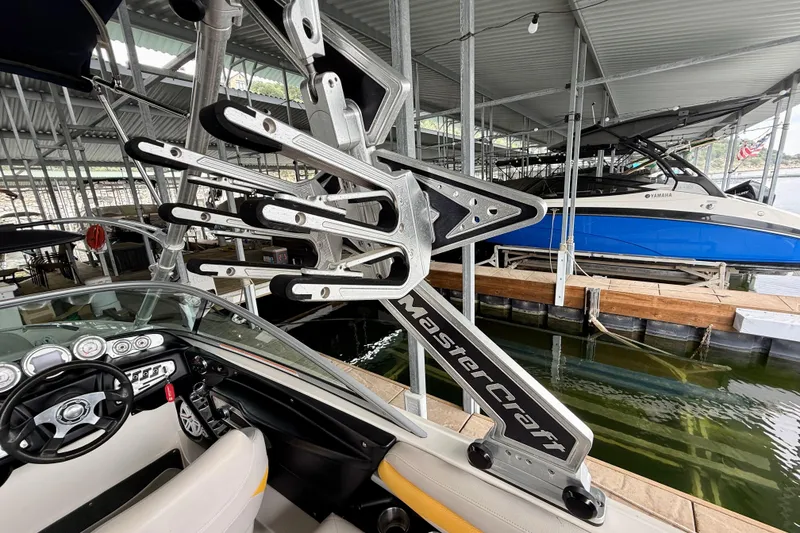 Slide: The Image of 2009 MasterCraft X30 boat with wakeboard rack in marina setting. - 28