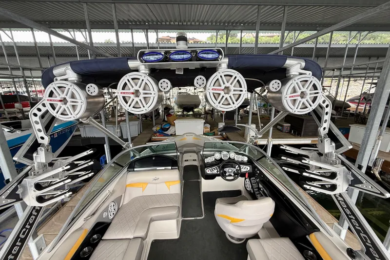 Slide: The Image of 2009 MasterCraft X30 boat interior with advanced audio system and sleek design in a covered dock. - 29