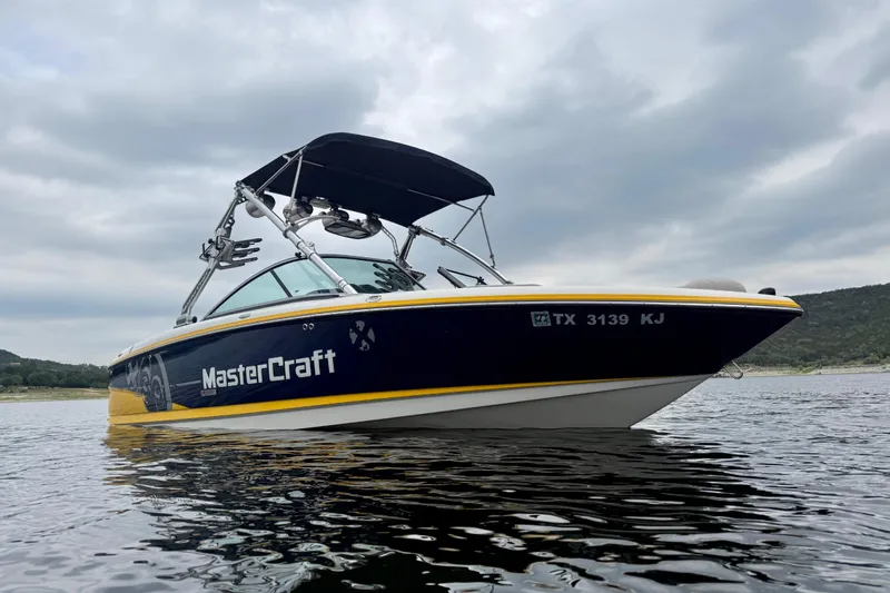 Slide: The Image of 2009 MasterCraft X30 boat on water under cloudy sky. - 3