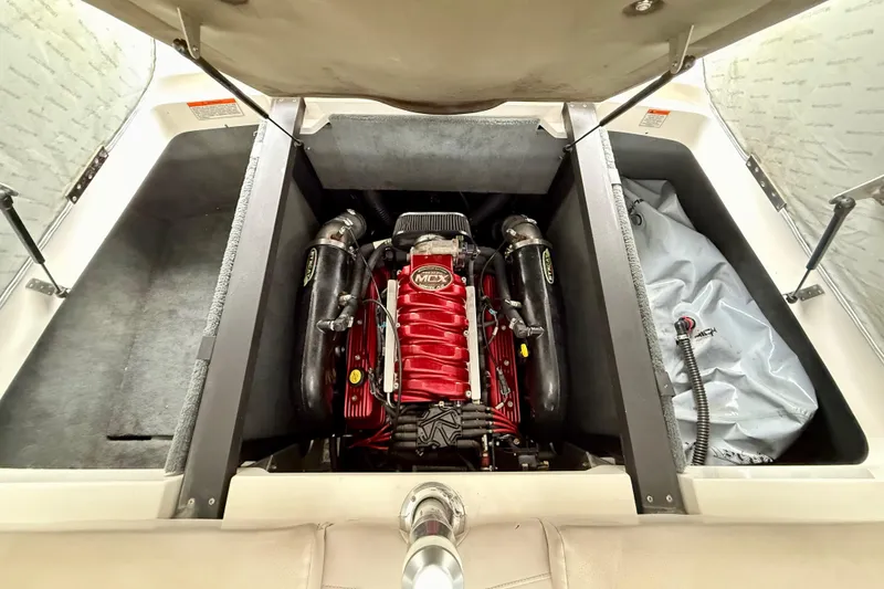 Slide: The Image of 2009 MasterCraft X30 engine compartment with red engine and storage space. - 30