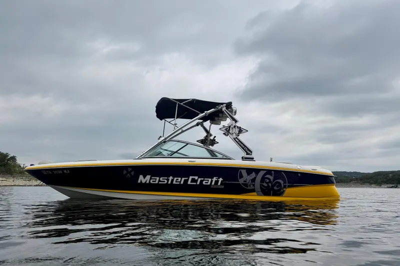 Slide: The Image of 2009 MasterCraft X30 boat on water under cloudy sky. - 7