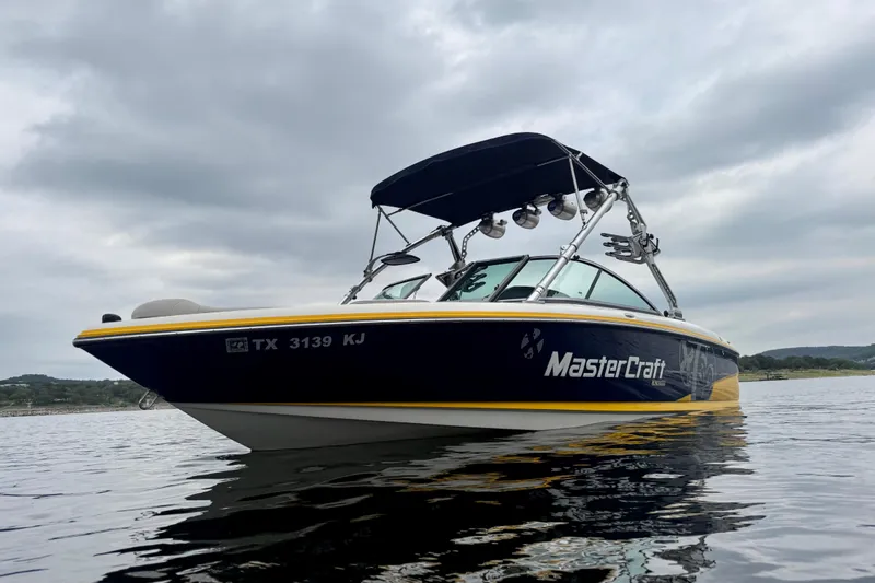 Slide: The Image of 2009 MasterCraft X30 boat on water under cloudy sky. - 8