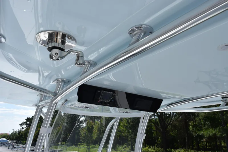 Slide: The Image of 2026 Contender 32 ST boat's sleek T-top with integrated electronics and polished metal supports. - 11