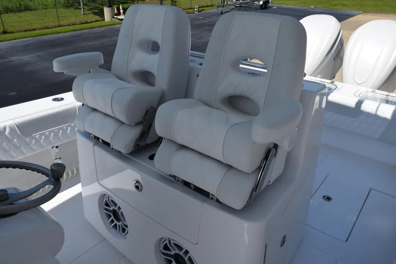 Slide: The Image of Luxury seating on 2026 Contender 32 ST boat, featuring plush white captain chairs. - 12