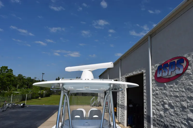 Slide: The Image of 2026 Contender 32 ST boat outside GSPS building under clear blue sky. - 15