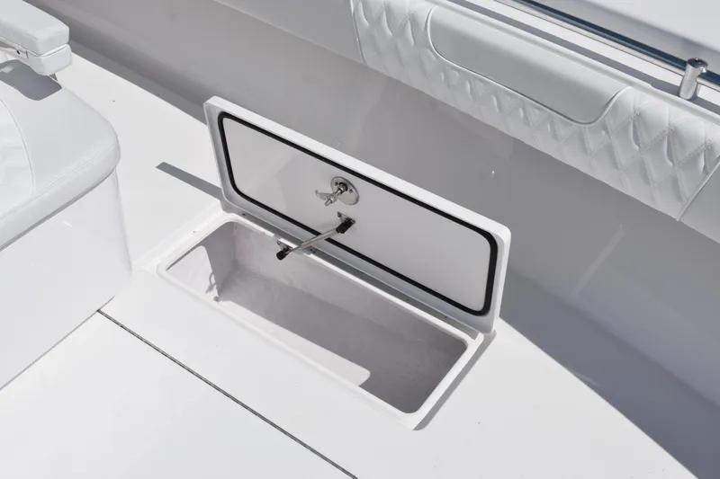 Slide: The Image of 2026 Contender 32 ST boat storage compartment with open hatch and sleek white interior. - 18