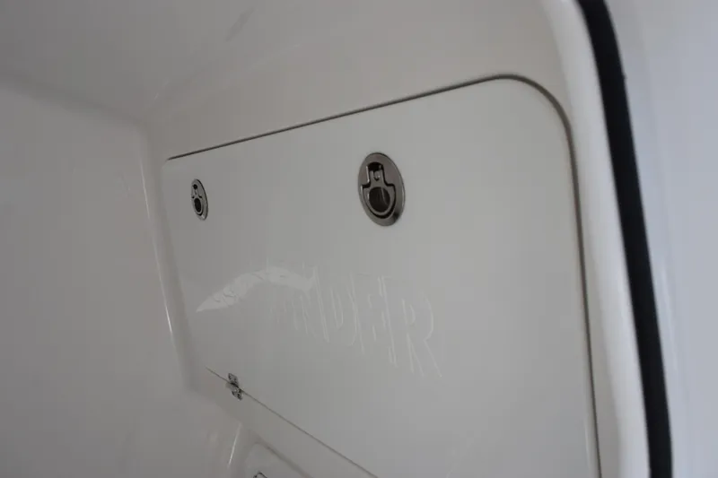 Slide: The Image of Contender 32 ST 2026 boat compartment with secure latch and embossed branding. - 21