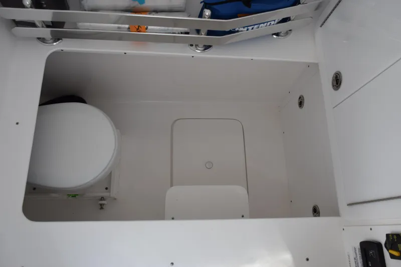 Slide: The Image of Interior of 2026 Contender 32 ST boat, featuring a compact marine toilet. - 22