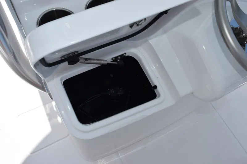 Slide: The Image of Open storage compartment on 2026 Contender 32 ST boat console. - 23