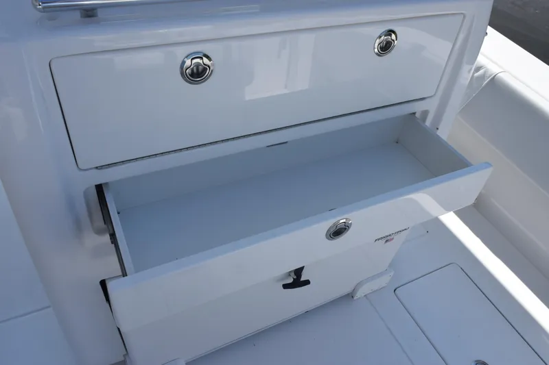Slide: The Image of Open storage compartment on a 2026 Contender 32 ST boat, featuring sleek white design. - 28
