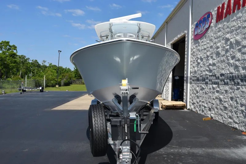 Slide: The Image of 2026 Contender 32 ST boat on trailer outside marine shop. - 3