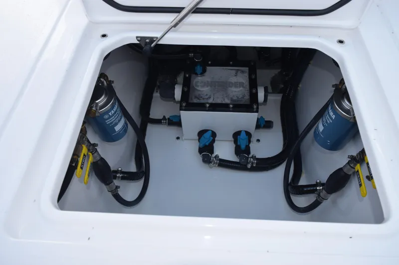 Slide: The Image of Engine compartment of 2026 Contender 32 ST boat, featuring Yamaha filters and hoses. - 30