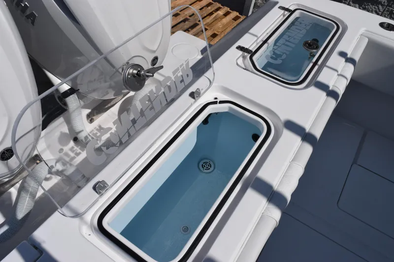 Slide: The Image of 2026 Contender 32 ST boat with open storage compartments and visible branding. - 31