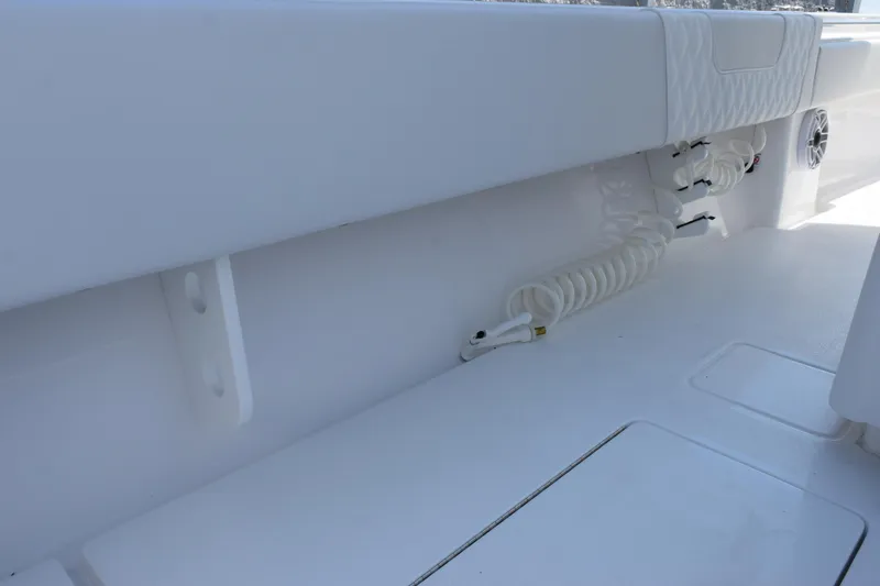 Slide: The Image of Interior view of 2026 Contender 32 ST boat, featuring clean white deck and coiled hose. - 32
