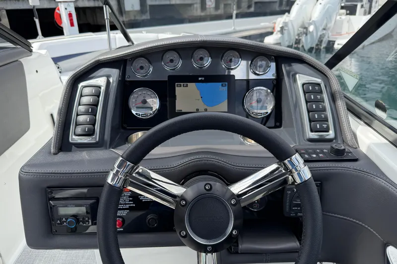 Slide: The Image of 2024 Formula 270 Bowrider dashboard with steering wheel and navigation controls. - 13