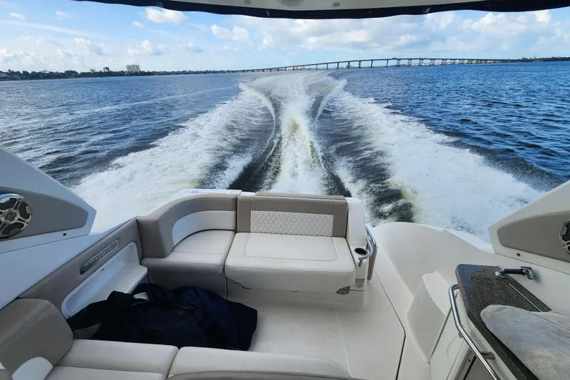 Slide: The Image of 2012 Chaparral 310 Signature cruising on open water, leaving a wake behind. - 13