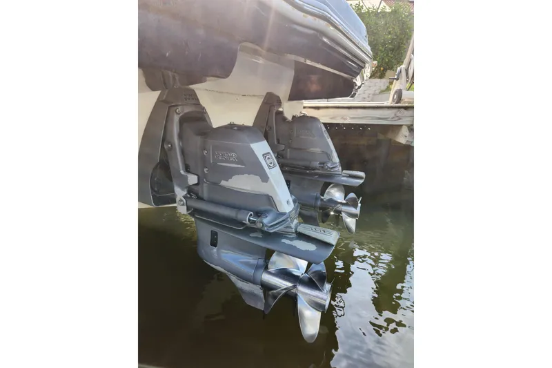 Slide: The Image of 2012 Chaparral 310 Signature boat with dual Volvo Penta outdrives in water. - 4