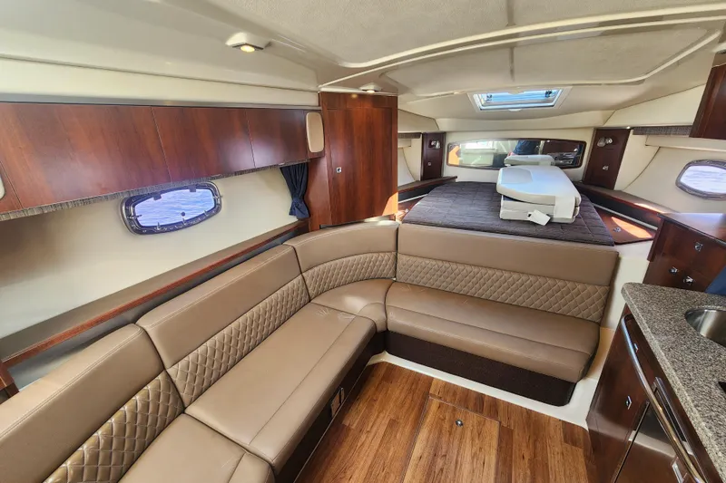 Slide: The Image of Luxurious interior of 2012 Chaparral 310 Signature yacht with elegant seating and wood finishes. - 8