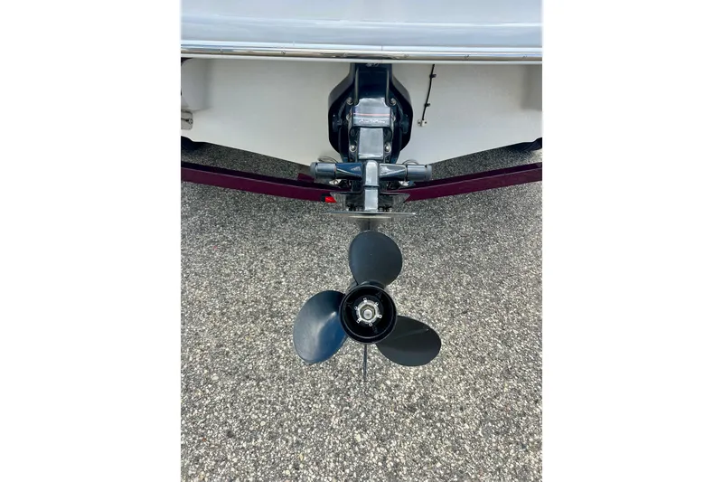 Slide: The Image of Rear view of a 2007 Crownline 180 BR boat propeller on pavement. - 10