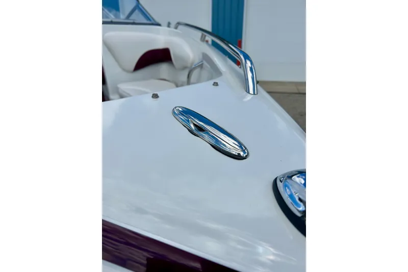Slide: The Image of 2007 Crownline 180 BR boat, close-up of sleek white exterior and chrome details. - 13