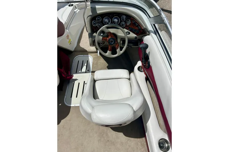 Slide: The Image of 2007 Crownline 180 BR boat interior with steering wheel and dashboard controls. - 22
