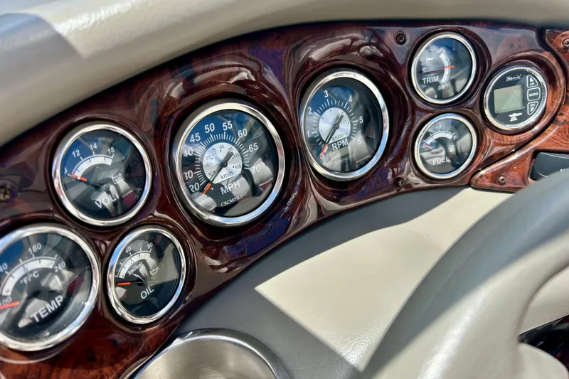 Slide: The Image of Dashboard of a 2007 Crownline 180 BR boat with various gauges and controls. - 23