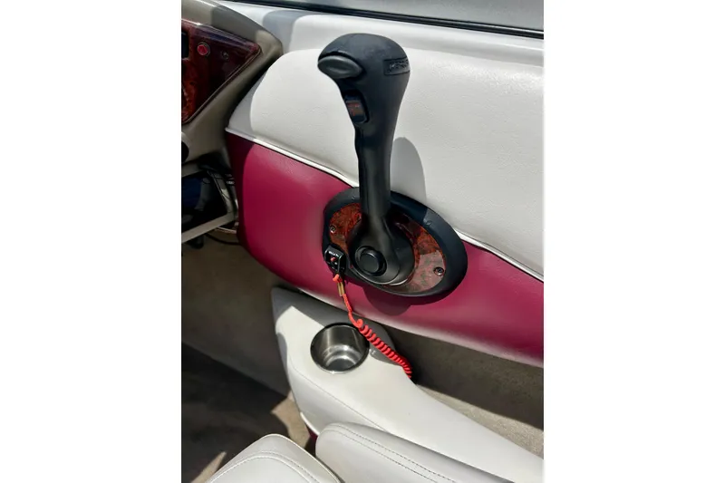 Slide: The Image of Throttle control of a 2007 Crownline 180 BR boat with maroon and white interior. - 25