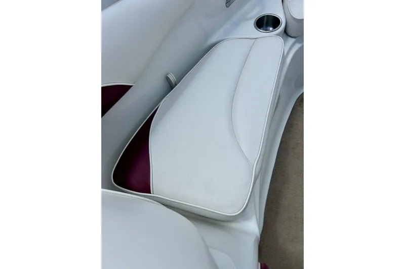 Slide: The Image of White leather seating in a 2007 Crownline 180 BR boat with cup holder. - 30