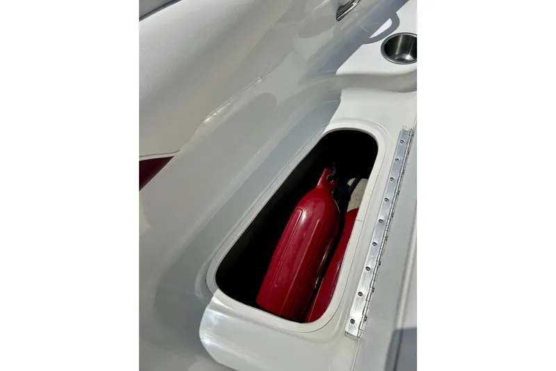 Slide: The Image of Storage compartment with red fender on 2007 Crownline 180 BR boat. - 31