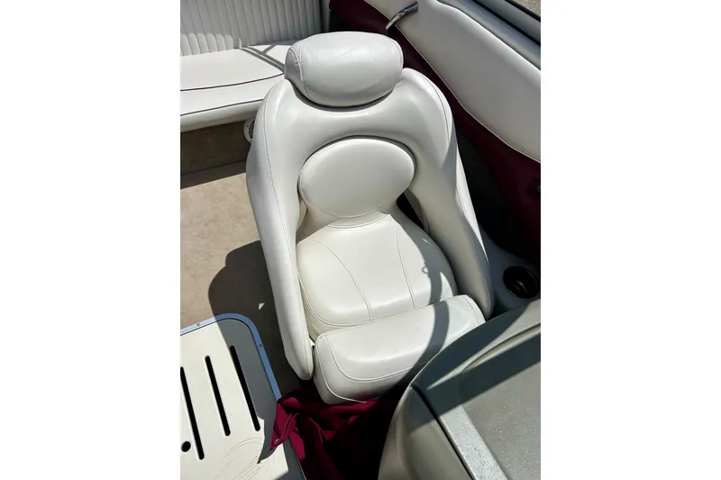 Slide: The Image of White leather seat in a 2007 Crownline 180 BR boat interior. - 32