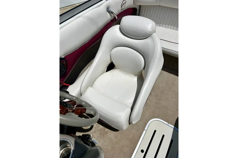 Slide: The Image of 2007 Crownline 180 BR boat interior with white leather seating and steering wheel. - 33