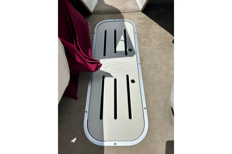 Slide: The Image of 2007 Crownline 180 BR boat interior with storage compartment and maroon fabric. - 36