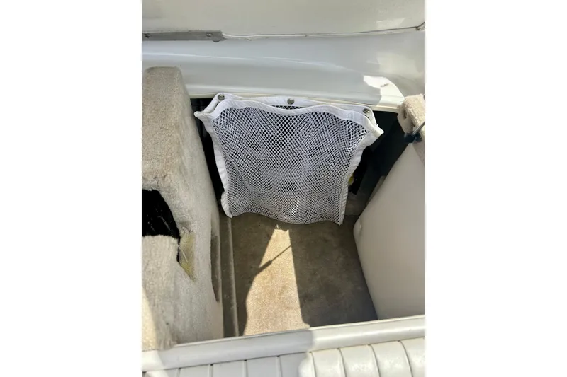 Slide: The Image of Interior storage compartment of 2007 Crownline 180 BR boat with mesh netting. - 39