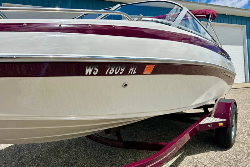 Slide: The Image of 2007 Crownline 180 BR boat on trailer, white and maroon color scheme. - 4