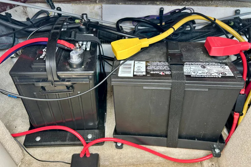 Slide: The Image of Dual batteries in a 2007 Crownline 180 BR boat with connected cables. - 41
