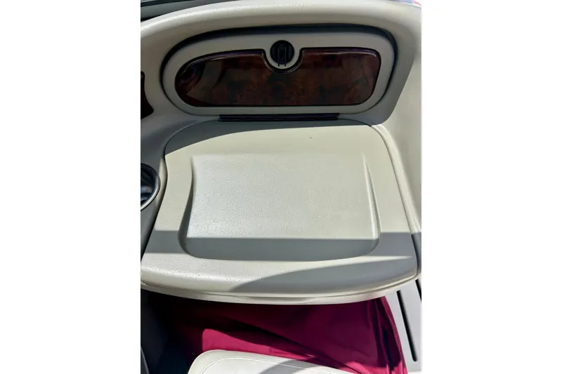 Slide: The Image of 2007 Crownline 180 BR boat dashboard with wood trim and storage compartment. - 42