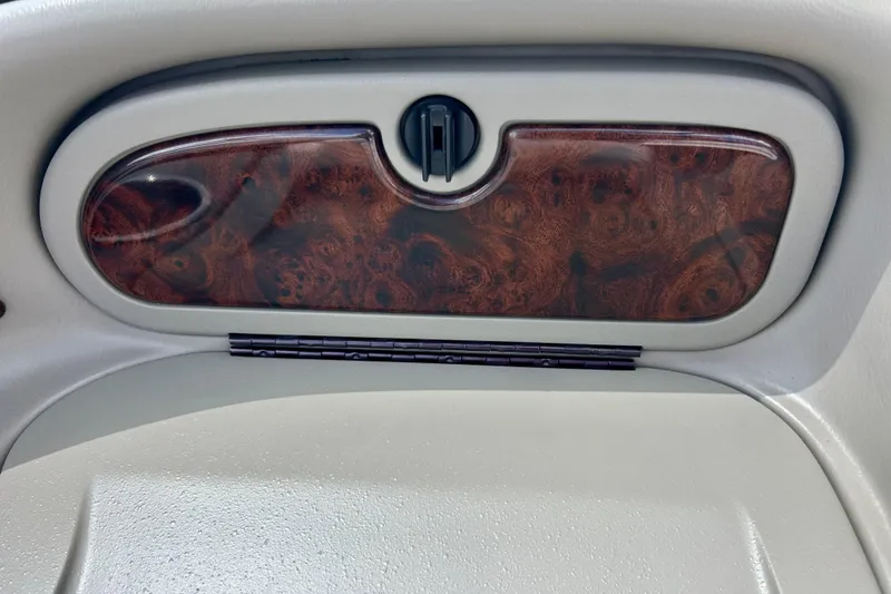 Slide: The Image of 2007 Crownline 180 BR dashboard with wood grain finish and storage compartment. - 44