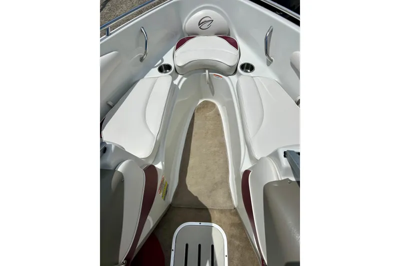Slide: The Image of 2007 Crownline 180 BR boat interior with white seating and cup holders. - 49