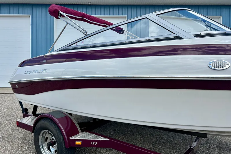 Slide: The Image of 2007 Crownline 180 BR boat with maroon and white exterior on a trailer. - 6