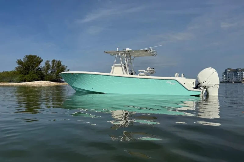 Slide: The Image of 2014 SeaVee 290B boat on calm water near a small island. - 1
