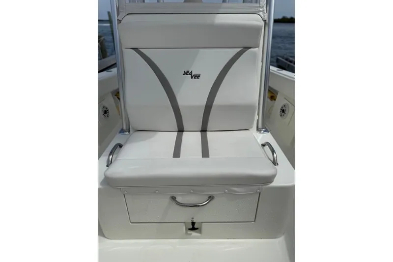 Slide: The Image of 2014 SeaVee 290B boat seat with storage, featuring sleek white and gray design. - 14