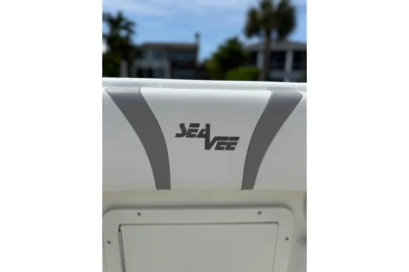Slide: The Image of 2014 SeaVee 290B boat logo with sleek design elements in a sunny setting. - 17