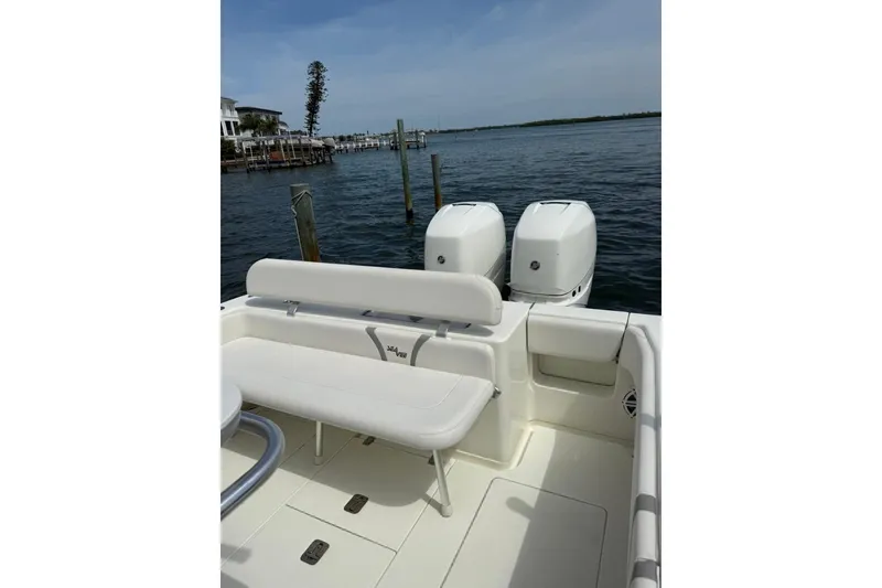 Slide: The Image of 2014 SeaVee 290B boat with dual engines, white seating, and ocean backdrop. - 19