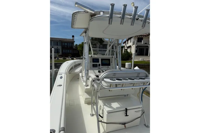 Slide: The Image of 2014 SeaVee 290B boat interior with helm, rod holders, and cooler. - 20