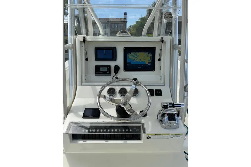Slide: The Image of 2014 SeaVee 290B boat helm with navigation screens and controls. - 21