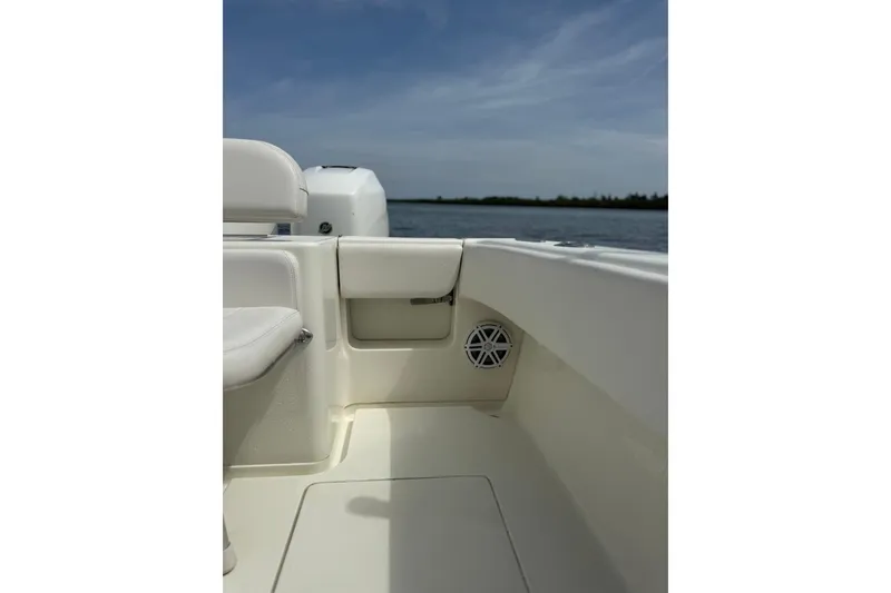 Slide: The Image of 2014 SeaVee 290B boat interior with seating and speaker, overlooking calm waters. - 4