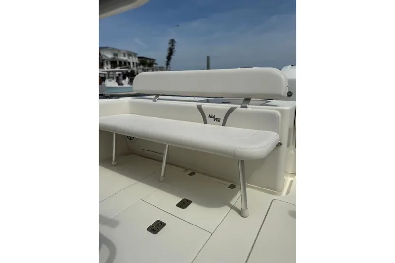 Slide: The Image of 2014 SeaVee 290B boat with white cushioned seating and sleek design. - 5